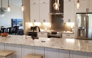 new kitchen with white cabinets and granite countertops